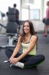 Happy Woman Having A Break From Exercising In Health Club Stock Photo