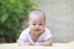 Close Up Face Of Smiling Baby Lying On Soft Bed At Home Terace U Stock Photo