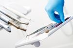 Hand Taking Dental Instruments Stock Photo