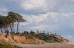 Beach And Cliffs In Quarteira Stock Photo