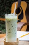 Matcha Tea With Milk On Creative Work Table Stock Photo