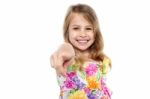 Portrait Of A Cheerful Kid Pointing Towards You Stock Photo