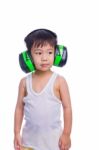 Young Asian Boy In A White Singlet Wearing Earmuffs Stock Photo