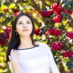 Young Beautiful Woman With Long Straight Dark Hair Posing In Spr Stock Photo