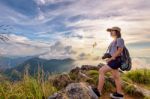 Girl Tourist On Mountains At Sunset Stock Photo