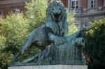 Statue Of A Lion Guarding The Margaret Bridge In Budapest Stock Photo