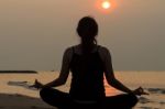 Asian Woman Practicing Yoga At Peace Sea In Morning Stock Photo