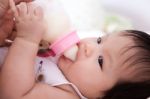 Pretty Baby Girl Is Drinking Milk Stock Photo