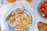 Turkey Steak With French Fries And Tomato Salad Stock Photo