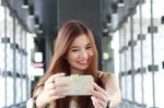 Portrait Of Thai Adult Beautiful Girl Using Her Smart Phone Selfie Stock Photo