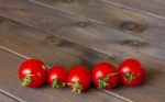 Fresh Tomatoes On The Dark Wooden Table Stock Photo