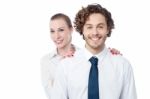 Businesswoman Hiding Behind Her Coworker Stock Photo