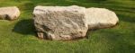 A Large Stone On Grass Stock Photo