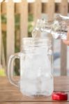 Drinking Water Is Poured Into Iced Glass Stock Photo