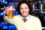 Happy Man Offering Glass Of Beer, Let's Celebrate Stock Photo