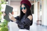 Portrait Of Thai Teen Beautiful Girl Using Her Tablet Stock Photo