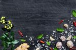 Top View Of Food Ingredients And Condiment On The Table, Ingredients And Seasoning On Dark Wooden Floor Stock Photo