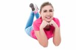 Young Girl Lying On The Floor Stock Photo