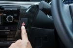 Closeup Of Young Woman Pressing Emergency Button On Car Sport Dashboard Stock Photo