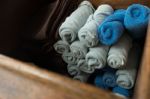 Light Gray And Blue Rolled Spa Massage Towel In The Wooden Box Stock Photo