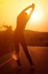 Woman Exercising Outdoor At Sunset  Stock Photo