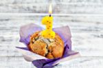 Muffin With Burning Candle Stock Photo