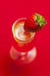 Glass Of Champagne With A Strawberry Stock Photo