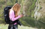 Woman At Mountain  On Mobile Phone Stock Photo