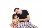 Loving Father Sitting With Daughter Stock Photo