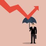 Businessman Holding Umbrella Protect Graph Down Stock Photo