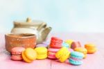 Colorful Macarons On A Pink Wooden Table Stock Photo