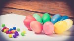 A Few Colorful Easter Eggs As A Flower Shape With Candies Over Wood Background Close Up Happy Easter Stock Photo