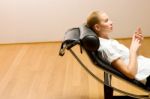 Woman Lying On Chaise Longue Stock Photo