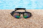 Glasses For Swimming On A Cement Floor With Small Stone Near Swi Stock Photo