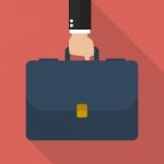 Businessman Hand Holding Briefcase Stock Photo