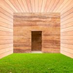 Stone Wall With Door And Green Grass Floor In Wooden Room Stock Photo