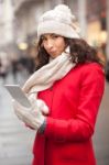 Woman In Red Coat And Wool Cap And Gloves With Smartphone In Han Stock Photo