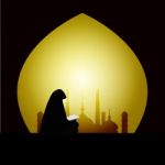 Muslim Woman Reading Quran On Sunset Background Stock Photo
