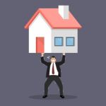 Businessman Carry A Heavy Home Stock Photo