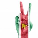 Suriname Flag On Victory Hand Stock Photo