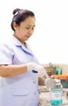 Female Nurse Open Alcohol Bottle Stock Photo