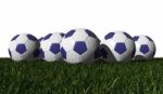 Blue Soccer Balls On A Green Grass Stock Photo