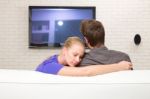 Man Watching Tv Woman Embraces Him Stock Photo