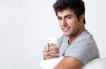 Happy Young Man With A Steamy Cup Of Coffee At Home Stock Photo