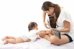 Mother Is Playing A Guitar For Her Baby Stock Photo