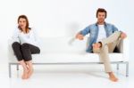 Separated Couple On Sofa Stock Photo