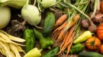 Several Vegetables On Wooden Chopping Board And Table Stock Photo