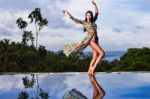 Pretty Brunette Model In Bikini Posing At The Pool Stock Photo