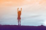 Silhouette Of Woman Praying Over Beautiful Sky Background Stock Photo