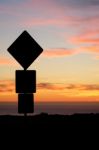 Road Sign Silhouette And Colorful Sunset Stock Photo